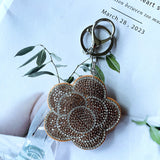 Cross-border rose plum blossom camellia korean velvet hot diamond keychain fashionable cute bag car pendant wholesale